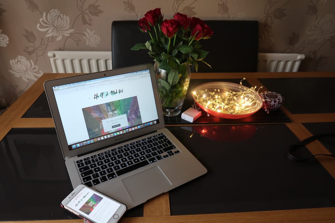 Laptop on a table showing the Life Of A Blind Girl blog with roses and fairy lights